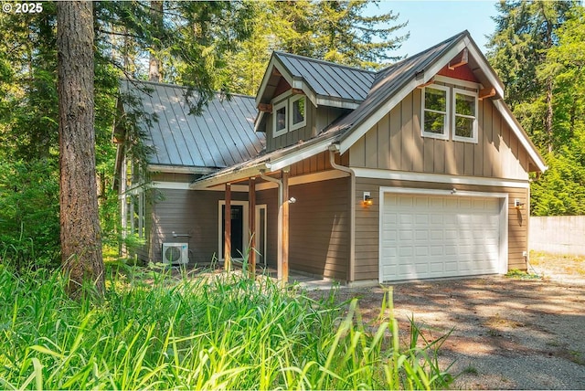 25815 NE Lucia Falls Rd, Yacolt, WA 98675 - view of front of house with driveway, a standing seam roof, board and batten siding, a metal roof, and an attached garage
