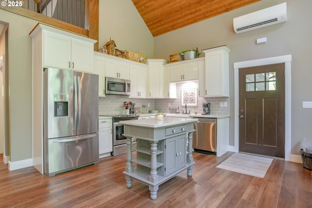 25815 NE Lucia Falls Rd, Yacolt, WA 98675 - kitchen featuring stainless steel appliances, a wall unit AC, light countertops, open shelves, and white cabinetry