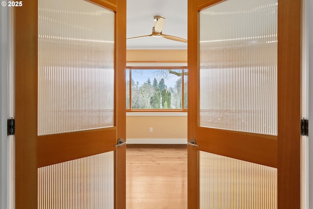 interior space featuring light wood-style flooring and baseboards