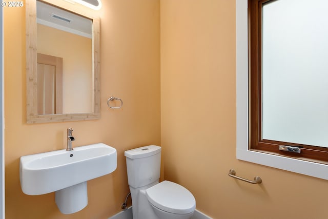 half bath featuring visible vents and toilet