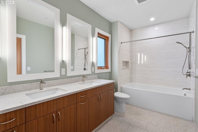 bathroom featuring  shower combination, double vanity, a sink, and toilet