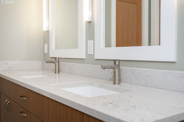 full bath with double vanity and a sink