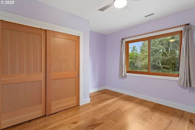 unfurnished bedroom featuring a ceiling fan, light wood-type flooring, visible vents, and baseboards