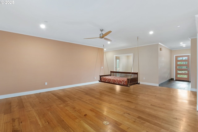 unfurnished living room with light wood-style floors and crown molding