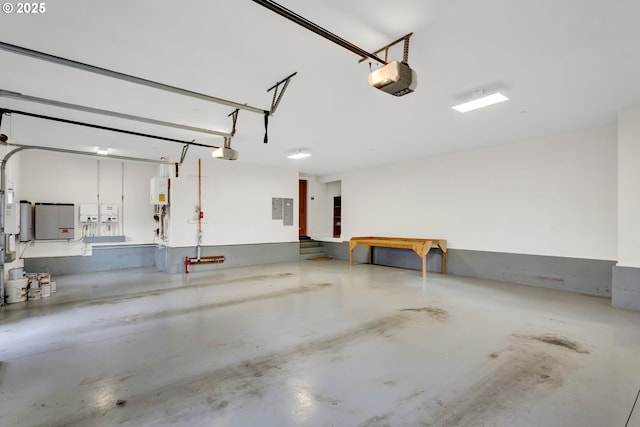 garage featuring a garage door opener, electric panel, and water heater