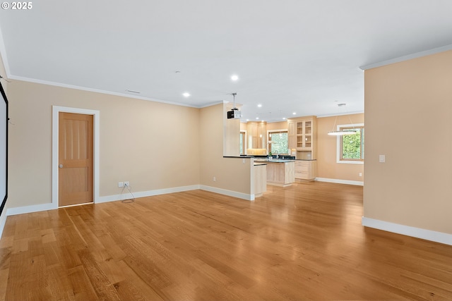 unfurnished living room with light wood finished floors, baseboards, crown molding, and recessed lighting