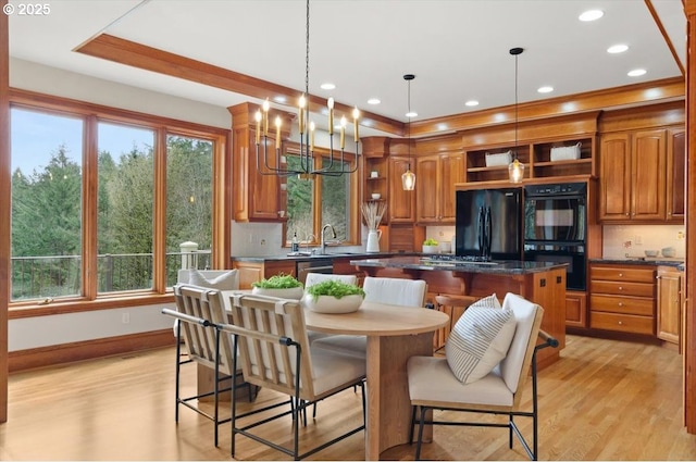 kitchen featuring open shelves, black appliances, a sink, light wood-type flooring, and ornamental molding
