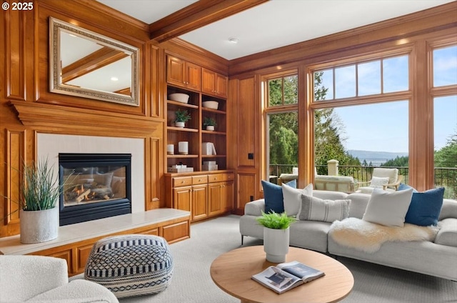 foyer featuring stairway, wood finished floors, a towering ceiling, a chandelier, and a glass covered fireplace