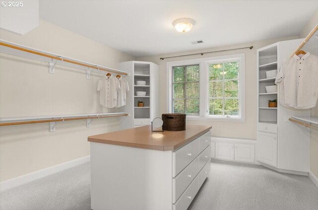 ensuite bathroom featuring a skylight, vanity, and recessed lighting