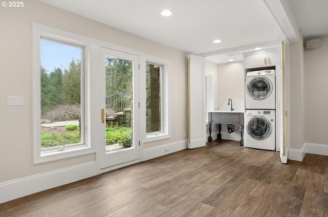 unfurnished living room featuring wood finished floors, recessed lighting, and baseboards