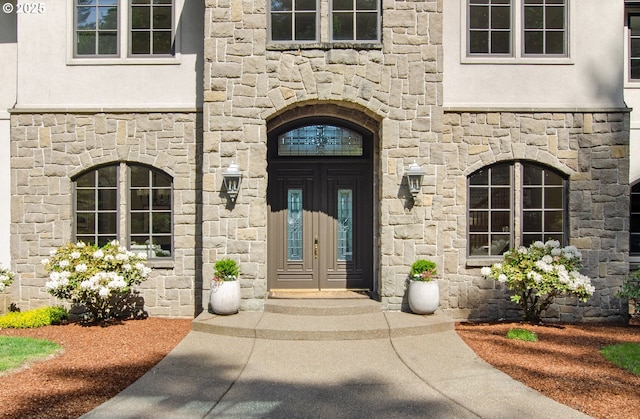 9440 NW Lightning Ridge Dr, Portland, OR 97229 - doorway to property featuring stone siding, stucco siding, and french doors