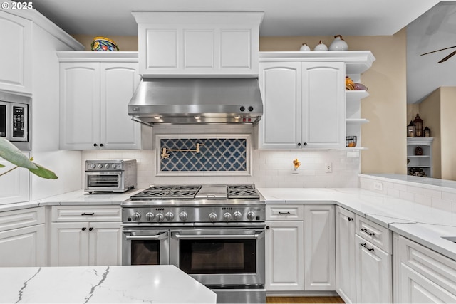 kitchen featuring white cabinets, open shelves, appliances with stainless steel finishes, and ventilation hood