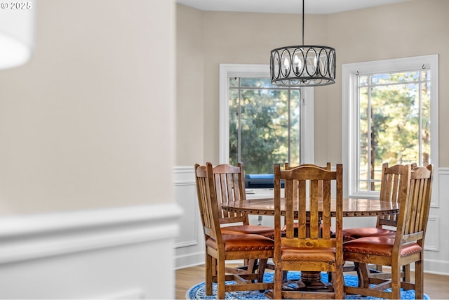 dining space with a chandelier and wood finished floors