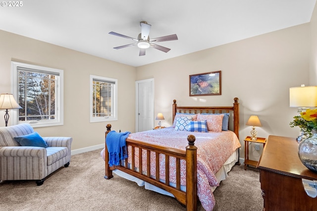 bedroom with a ceiling fan, carpet flooring, and baseboards