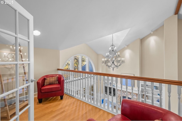 living area featuring vaulted ceiling and wood finished floors