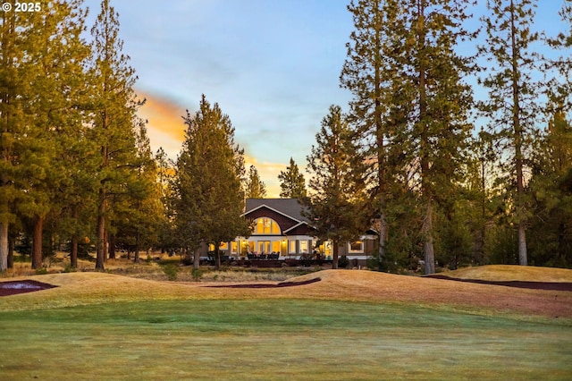 view of home's community with a yard