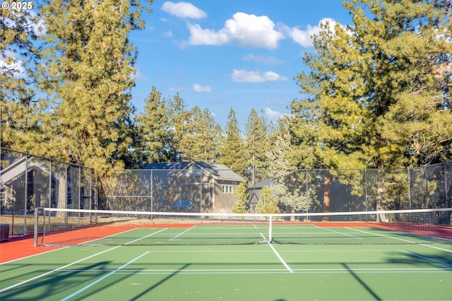 view of tennis court with fence