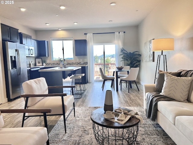 12958 SE 156th Ave, Happy Valley, OR 97086 - living room featuring light wood-style flooring, recessed lighting, and baseboards