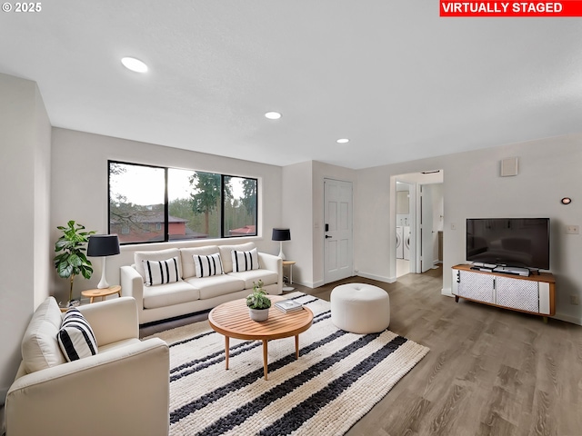 living room featuring recessed lighting, wood finished floors, visible vents, baseboards, and washer / clothes dryer