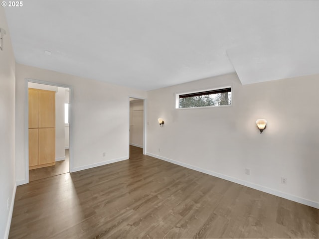 empty room featuring baseboards and wood finished floors