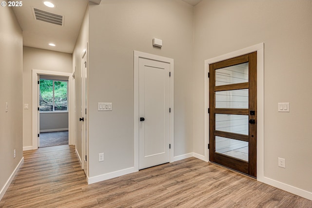 entryway featuring light wood-type flooring, baseboards, and recessed lighting