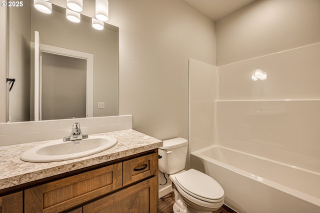 full bath featuring toilet, vanity,  shower combination, and wood finished floors