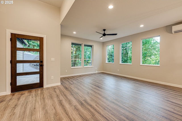 entryway featuring healthy amount of natural light, a ceiling fan, recessed lighting, wood finished floors, and baseboards