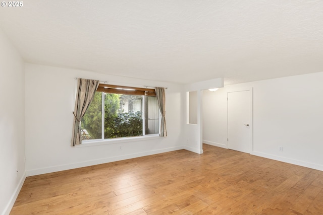 spare room with light hardwood / wood-style flooring