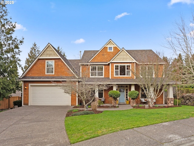 craftsman house with a garage, concrete driveway, fence, a porch, and a front yard