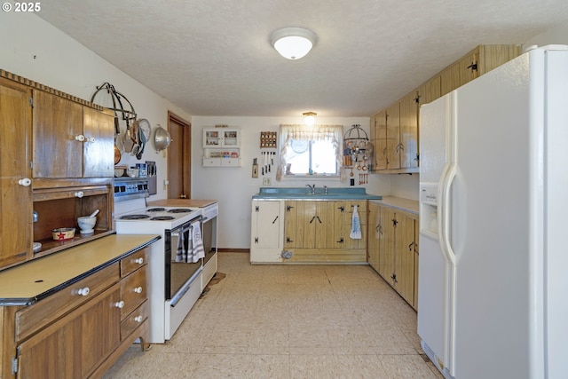 19587 NW Adcock Rd, Yamhill, OR 97148 - kitchen with white appliances, light flooring, light countertops, a textured ceiling, and baseboards