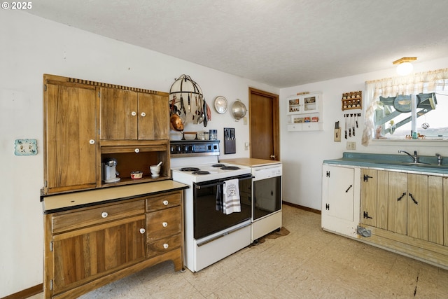 19587 NW Adcock Rd, Yamhill, OR 97148 - kitchen featuring electric stove, light flooring, a sink, a textured ceiling, and baseboards