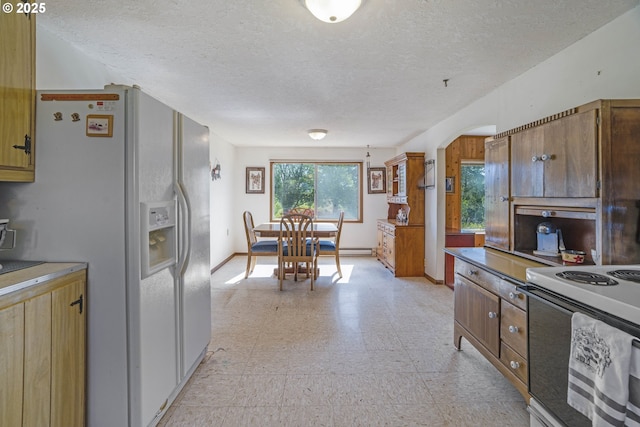 19587 NW Adcock Rd, Yamhill, OR 97148 - kitchen featuring white appliances, light floors, a textured ceiling, arched walkways, and baseboards