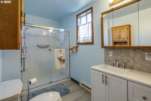 19587 NW Adcock Rd, Yamhill, OR 97148 - bathroom with toilet, a baseboard heating unit, decorative backsplash, vanity, and a stall shower
