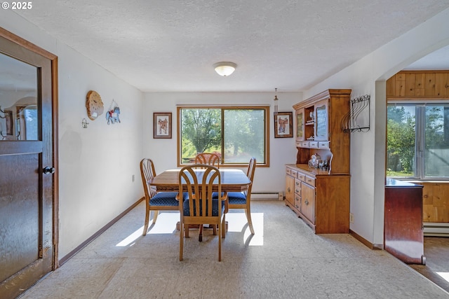 19587 NW Adcock Rd, Yamhill, OR 97148 - dining area with baseboard heating, baseboards, a textured ceiling, and light flooring