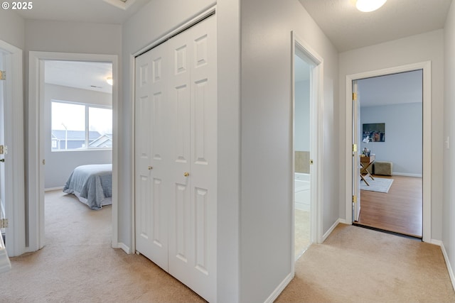 hallway with light colored carpet