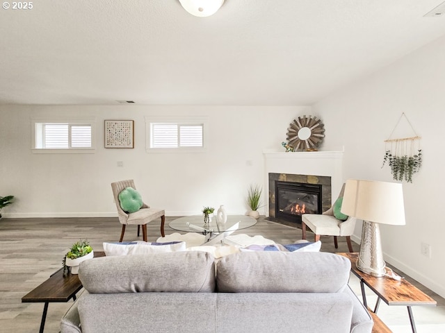 3547 SE 136th Ave, Portland, OR 97236 - living room with a fireplace with flush hearth, baseboards, healthy amount of natural light, and wood finished floors