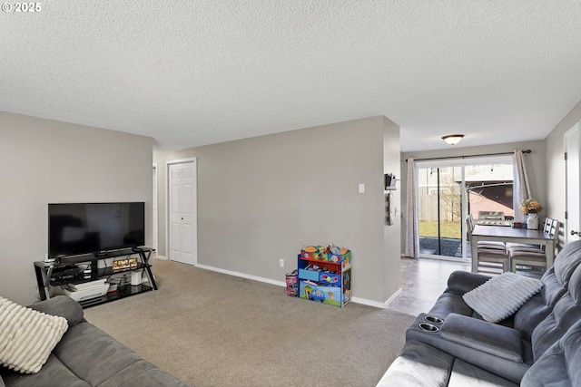 living room featuring light colored carpet and a textured ceiling