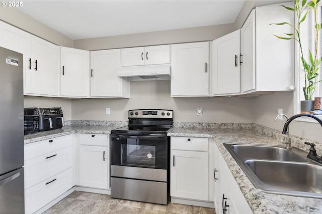 kitchen featuring stainless steel appliances, white cabinetry, and sink