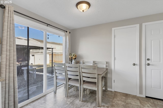 dining area with a textured ceiling