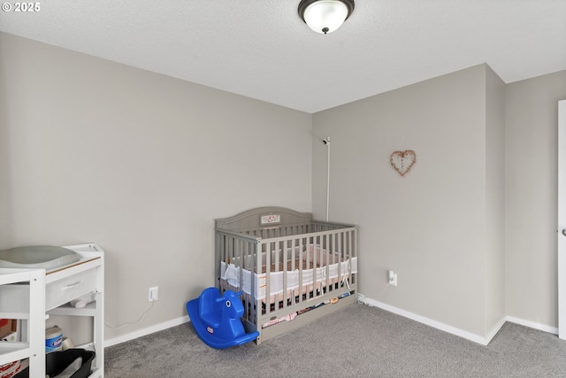 bedroom featuring carpet and a textured ceiling