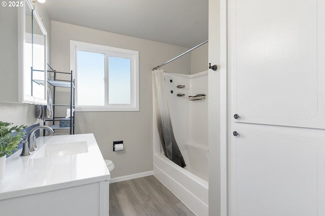 full bathroom featuring hardwood / wood-style flooring, vanity, shower / tub combo with curtain, and toilet