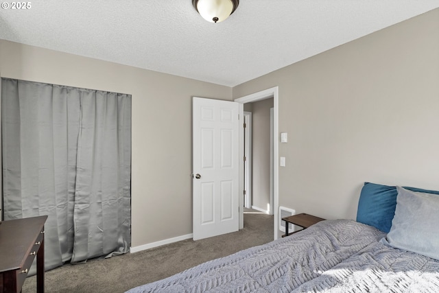 bedroom with carpet floors and a textured ceiling