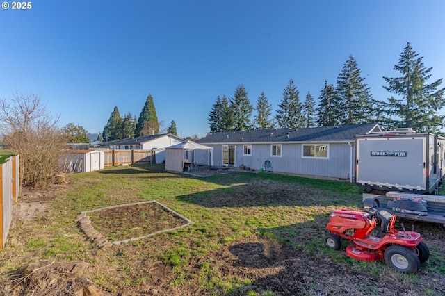 rear view of property with a shed and a lawn