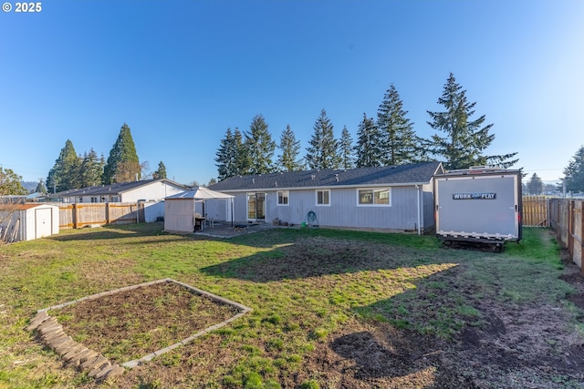 rear view of house featuring a lawn and a storage unit