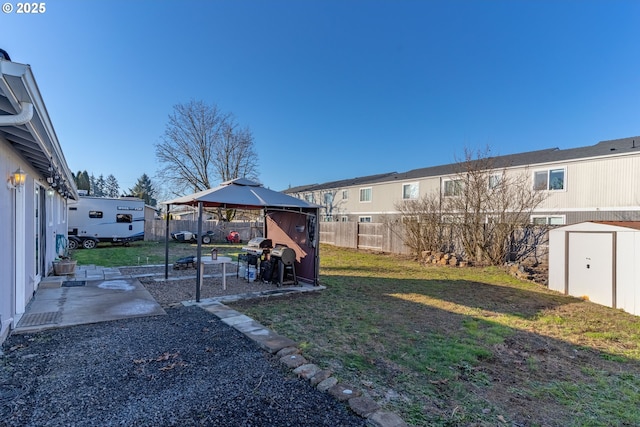 view of yard featuring a gazebo and a storage shed