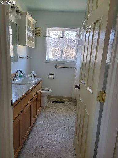 bathroom featuring vanity and toilet