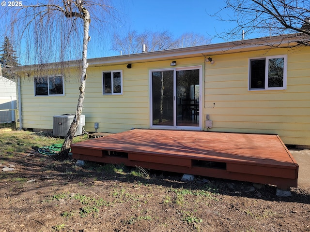 rear view of house with central AC unit and a deck