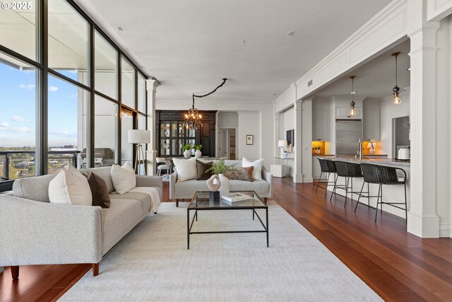 1025 NW Couch St Unit 1415, Portland, OR 97209 - living area with dark wood finished floors, a chandelier, plenty of natural light, expansive windows, and ornate columns