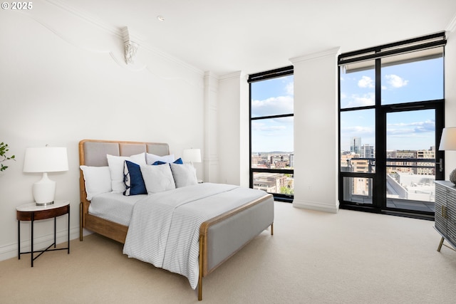 carpeted bedroom with baseboards, a view of city, floor to ceiling windows, and multiple windows