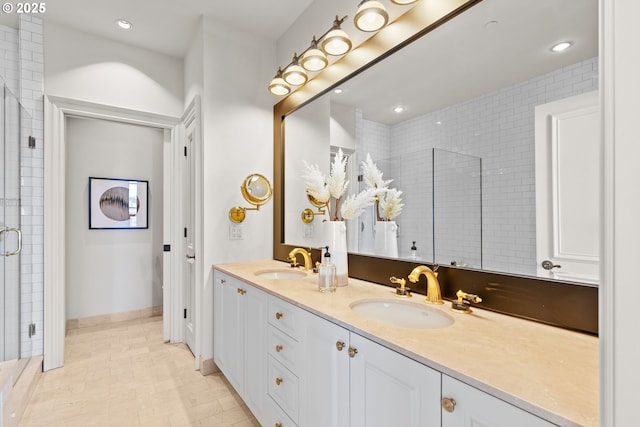 bathroom featuring double vanity, recessed lighting, a shower stall, and a sink